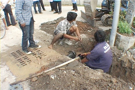 Council workers attempt to speed up completion work on the Soi Boon Nak water pipeline.